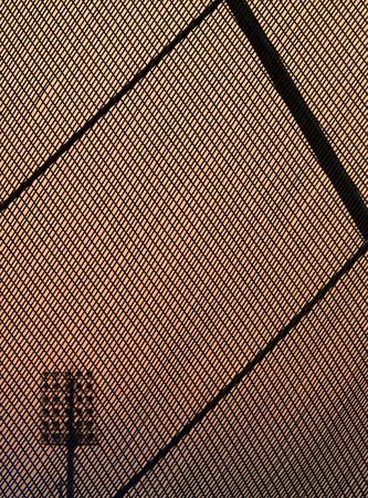 Decorative wire mesh of fence with sky sunset