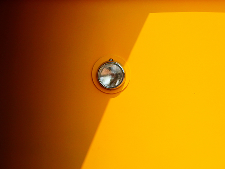 Headlight of yellow tram with shadowの写真素材