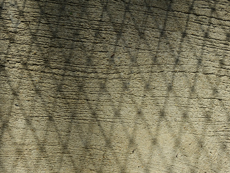 shadow of wire mesh fence on concrete floor textureの写真素材