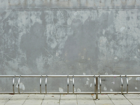 aged street wall with bicycle parkingの写真素材