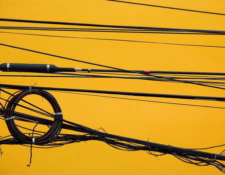 electric wire with yellow wall background