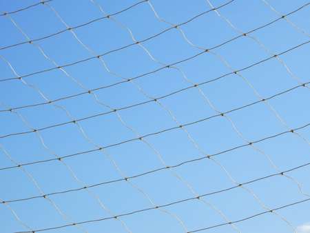 net of fence with blue sky backgroundの写真素材