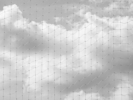 net of fence with cloud sky background black and white styleの写真素材