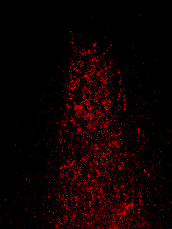 red water splash of fountain on black backgroundの写真素材