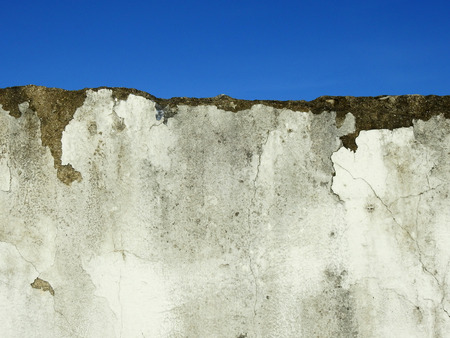 aged street wall with blue sky backgroundの写真素材