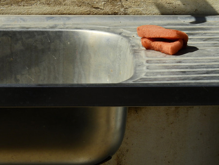 old dirty sink with sponge in kitchenの写真素材