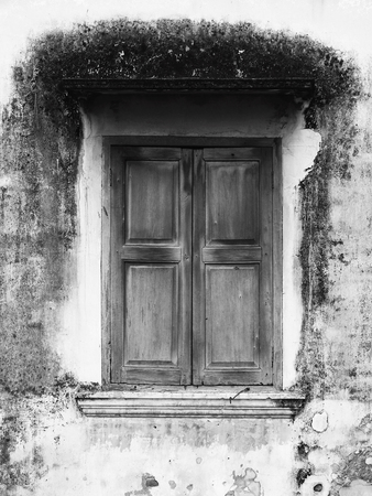 close wood window on wall of old homeの写真素材