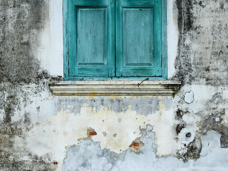 blue wood window close on dirty wall with modの写真素材