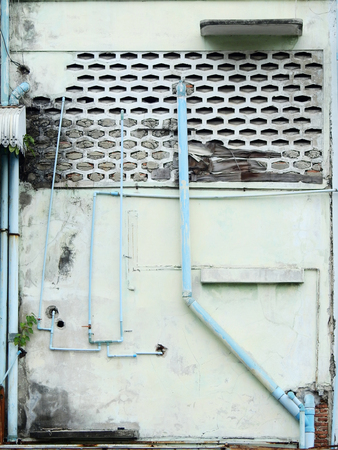 aged street wall with pipe, old homeの写真素材
