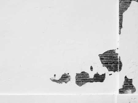 white cement plaster wall with crack texture backgroundの写真素材