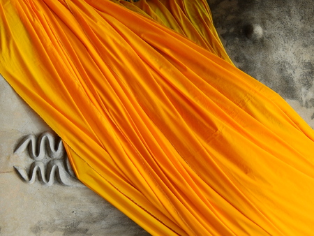 yellow fabric cover old buddha statueの写真素材