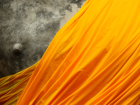yellow fabric cover old buddha statueの写真素材