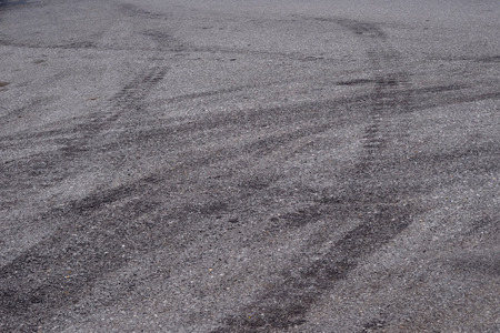 wheel track on asphalt road textureの写真素材
