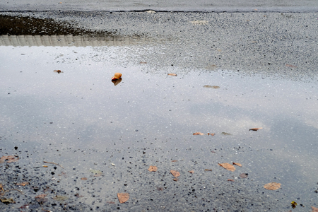wet asphalt road with water reflectionの写真素材