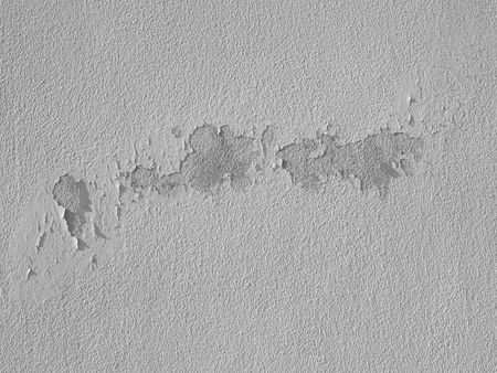 peeling dry color on white wall with crack textureの写真素材
