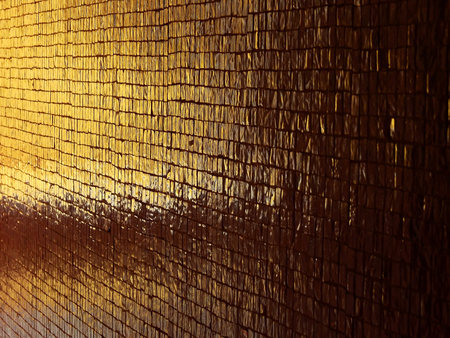 gold stone tile wall backgroundの写真素材