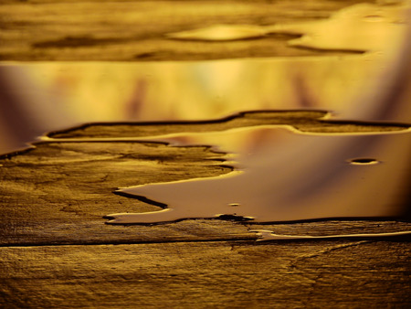 wet floor with golden water reflectionの写真素材