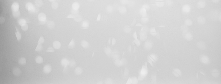 blur bokeh of sunlight on white wall backgroundの写真素材
