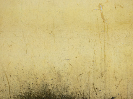 grunge yellow concrete wall backgroundの写真素材