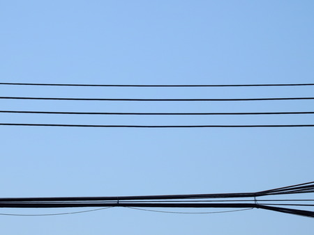 silhouette electric wire on blue sky backgroundの写真素材