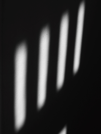 shadow on white wall with sunlight from window in the roomの写真素材
