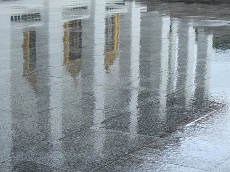 wet stone floor with water reflection after rain in temple Thailand