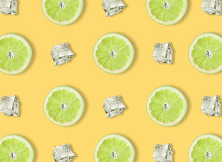 Creative look of cut lime rings with ice cubes on a pastel blue background. Minimal concept of...