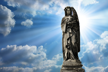 An angel public sculpture with clouds beckgroundの写真素材