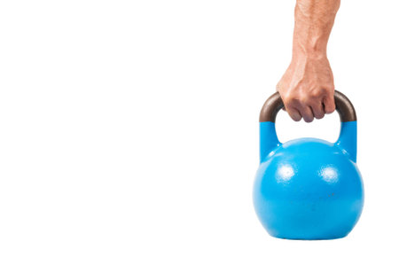 Hand holding Kettle Bell isolated on a white backgroundの写真素材