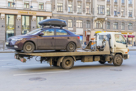 SAINT PETERSBURG, RUSSIA - APRIL, 2016: Tow truck takes the car on Ligovsky Avenue in Saint-Petersburgのeditorial素材