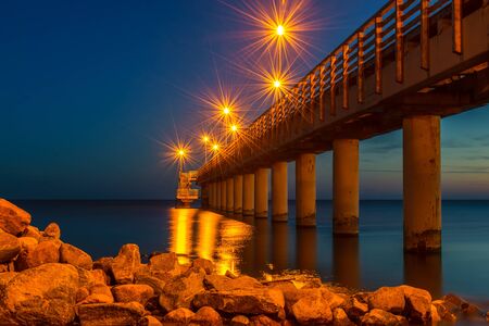 Pier with night lighting in the town of Zelenogradsk on the coast of the Baltic seaの写真素材