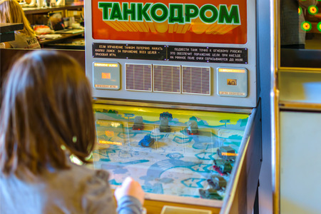 RUSSIA, SAINT PETERSBURG - January, 2016: the Museum of Soviet arcade games. Girl playingのeditorial素材