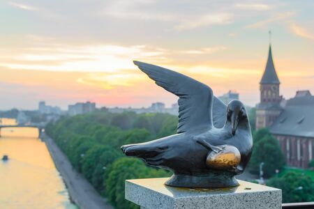 RUSSIA, KALININGRAD, - August, 2016: Kaliningrad. The sculpture "Bird of happiness" at the lighthouse Fishing village. The view of the Cathedral on Kant islandのeditorial素材