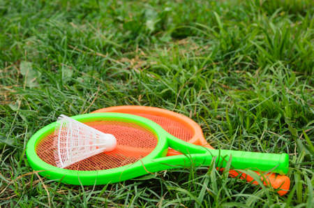 Two children's tennis rackets with a shuttlecock. Outdoor activities with children. Selective focus.の写真素材