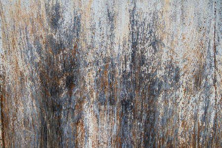 The texture of an old surface covered with white paint, cracked and peeling from time.