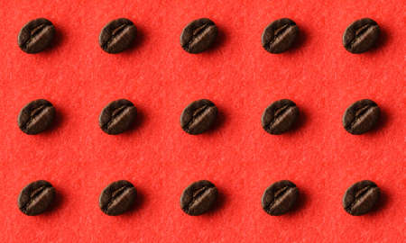 A seamless pattern of roasted coffee beans on a red fluffy fabric.の写真素材