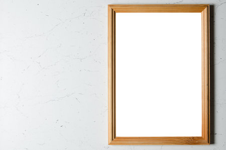 Mockup. An empty wooden photo frame on a textured gray wall.