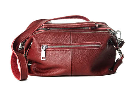 Womens burgundy bag made of artificial textured leather with lots of metal locksの写真素材