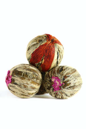 The leaves of green tea braided in balls isolated on a white background.の写真素材