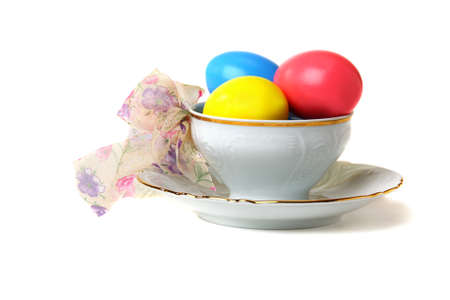 Easter eggs in a teacup isolated on a white background.の写真素材