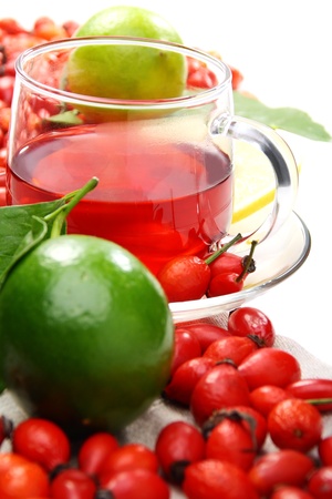 Vitamin tea with rose hips and lemon on a white background.の写真素材