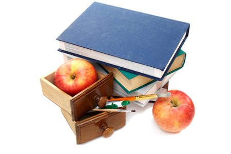 Books, school supplies and apples on a white background.の写真素材