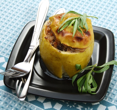 Apples stuffed with chicken, prunes and walnuts on a blue napkin.の写真素材