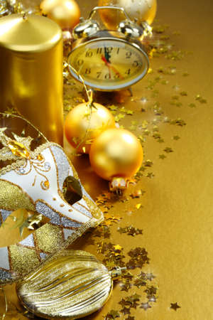 Christmas still life with balloons, candles and a clock on a gold background.の写真素材