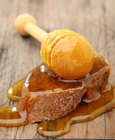 Honey and rye bread in an old wooden board.の写真素材
