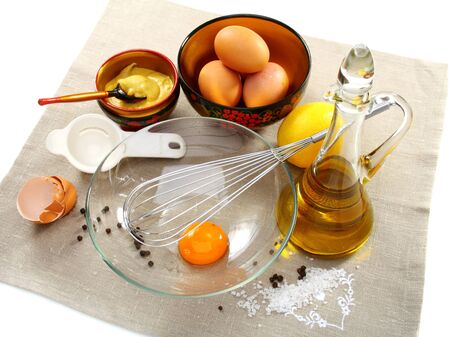 Mayonnaise with ingredients, including eggs, lemon, olive oil and whisk.  の写真素材