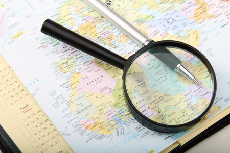 Diary, pen and magnifying glass on a map.  の写真素材