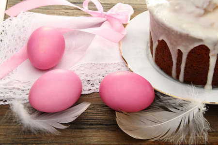 Easter cake and eggs on a wooden table.の写真素材