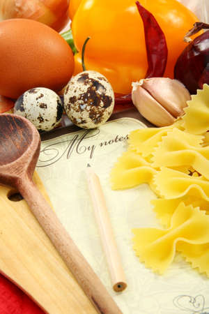 Recipe book on the table with food.の写真素材