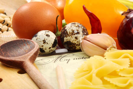 Recipe book on the table with food.の写真素材